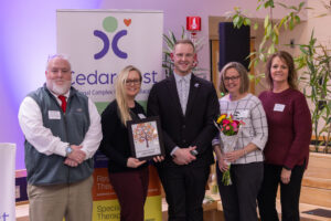 Representatives from Liberty Mutual stand with Jay Hayston and Kevin Forrest
